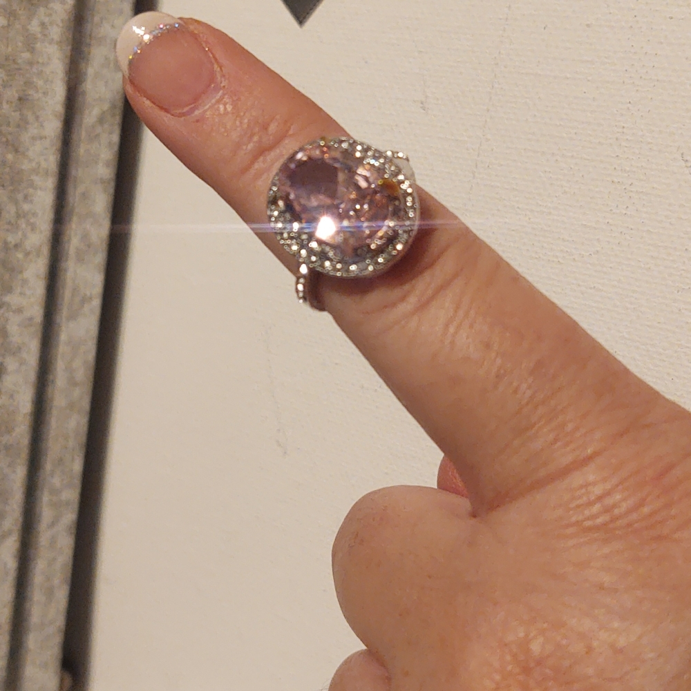 Pink simulated sapphire encased in sterling silver plated setting. Size 7